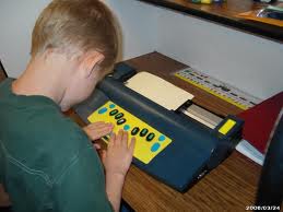 A student using a Braille machine